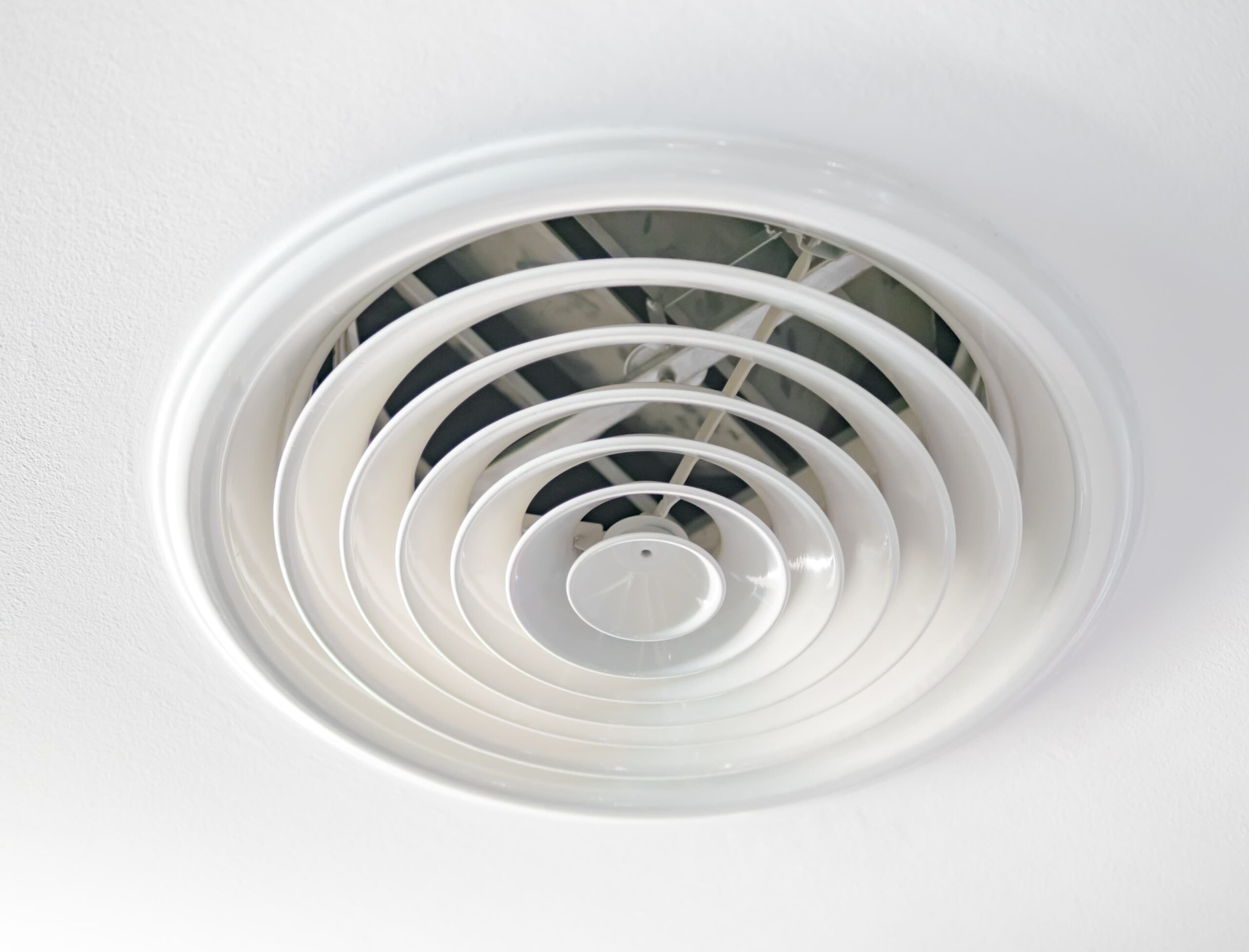 closeup of an air duct output vent on the ceiling